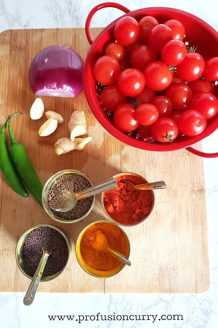 Display of ingredients to make tomato chutney recipe.