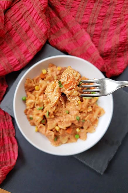 A fork holding a delicious Indo Italian pasta meal of creamy Makhani Pasta