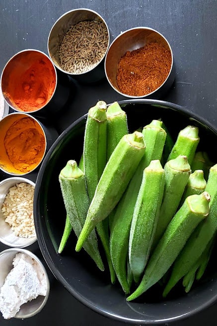 Display of ingredients used in making Indian spiced okra recipe.