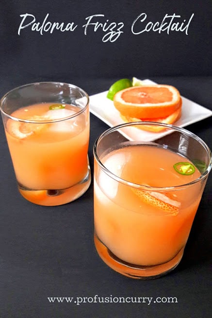 Two highball glasses filled with grapfruit -lime- tequila cocktail with ice. 