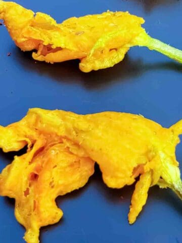 Fried zucchini flowers are light, crispy, and stuffed with creamy filling—perfect for summer appetizers! Try this easy recipe for zucchini blossom fritters too.