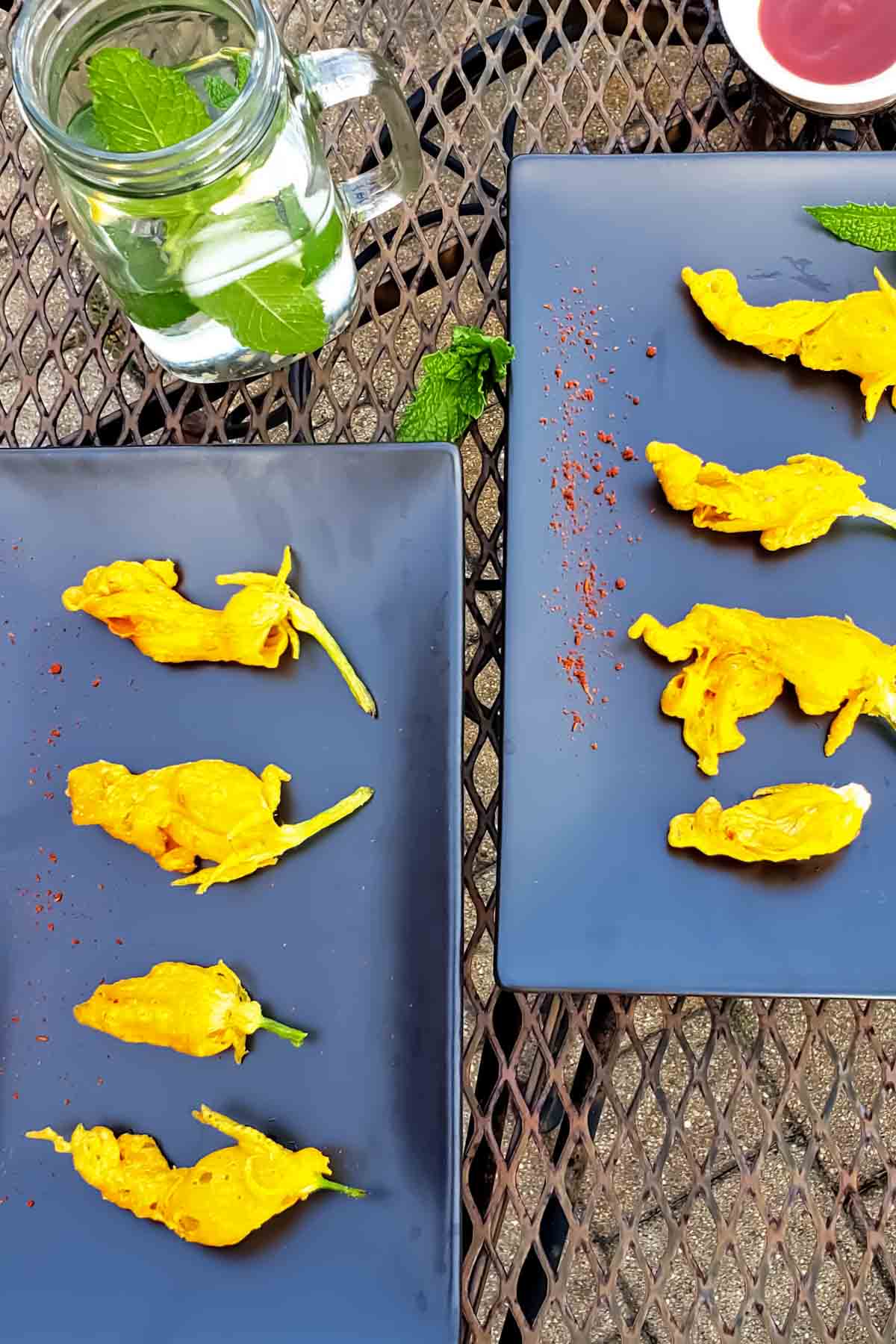 platter of zucchini blossom fritters which are also fried zucchini flowers served with drinks.