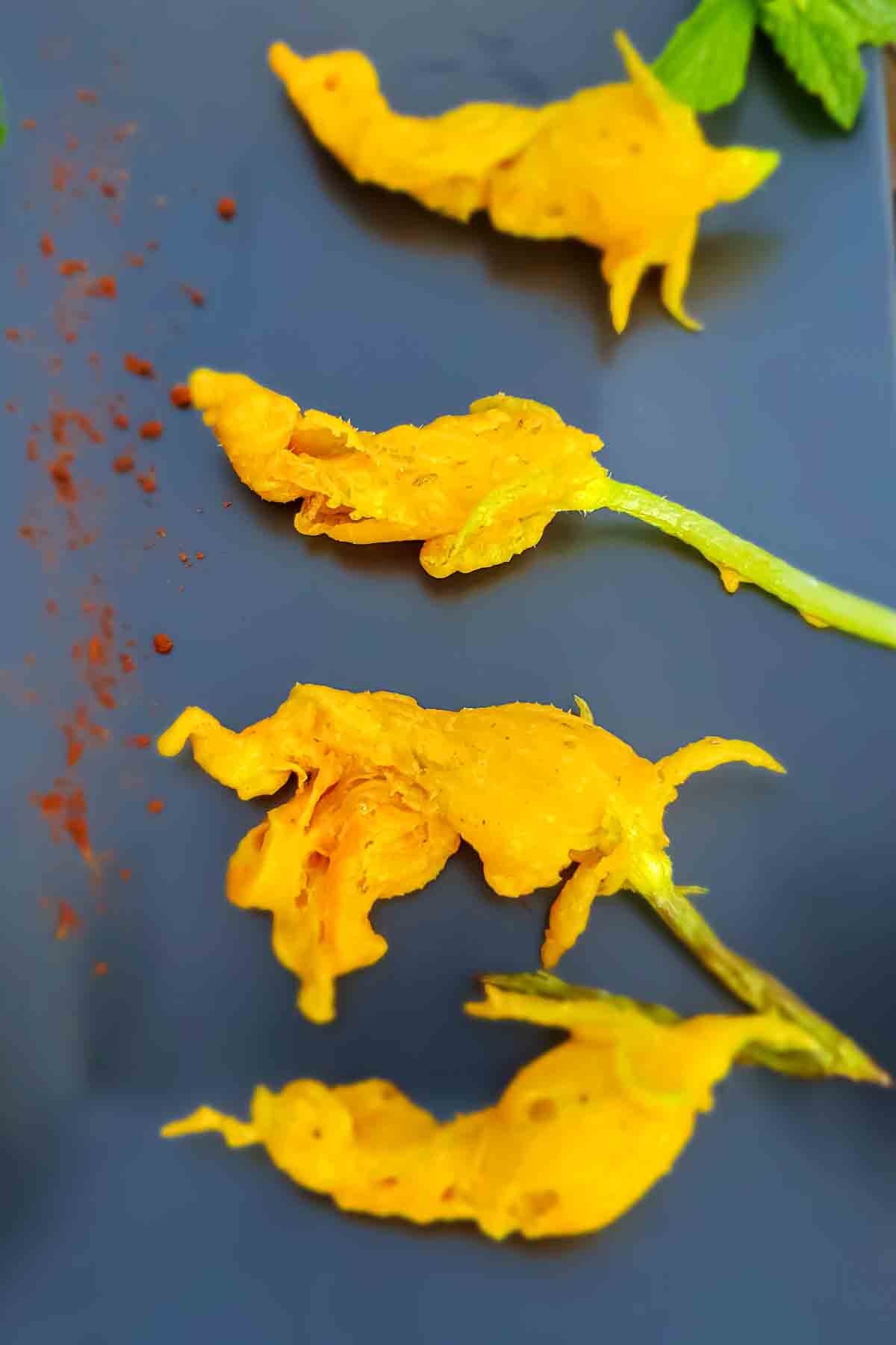 Fried zucchini flowers served on the platter for vegan and gluten free snack or appetizer. 