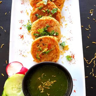 spicy potato cutlets served along with green chutney, cucumber and radish slices.