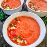 Healthy vegan gazpacho recipe blended with ripe tomatoes and colorful summer vegetables.