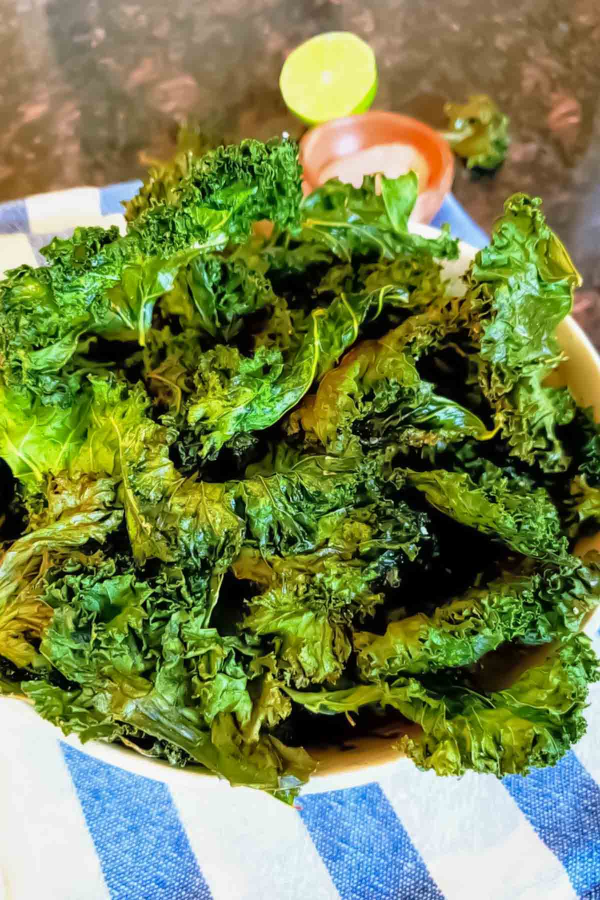 Crispy kale chips served in a bowl with light seasoning.