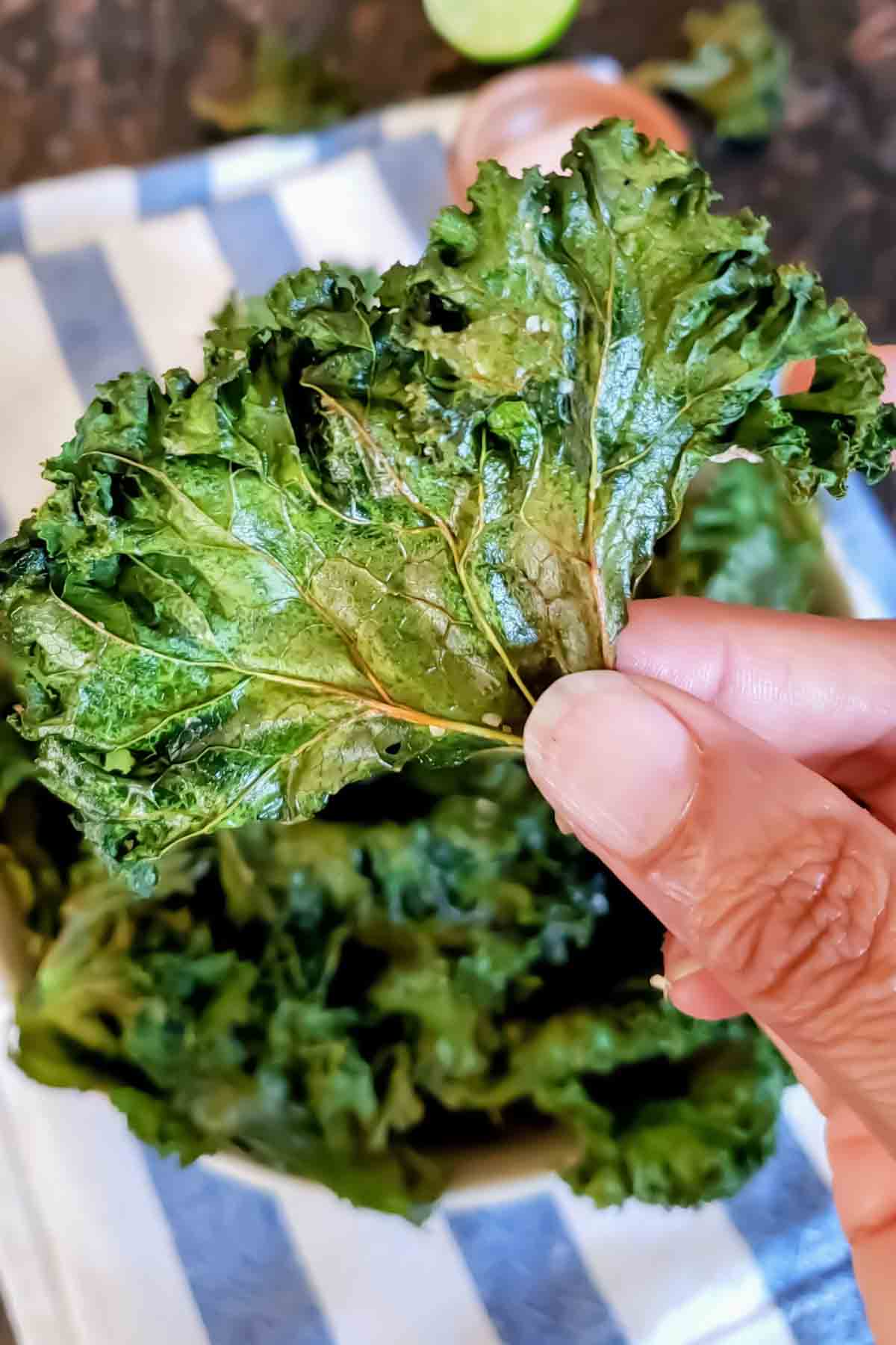 Close up of crunchy baked kale chips with crispy edges.