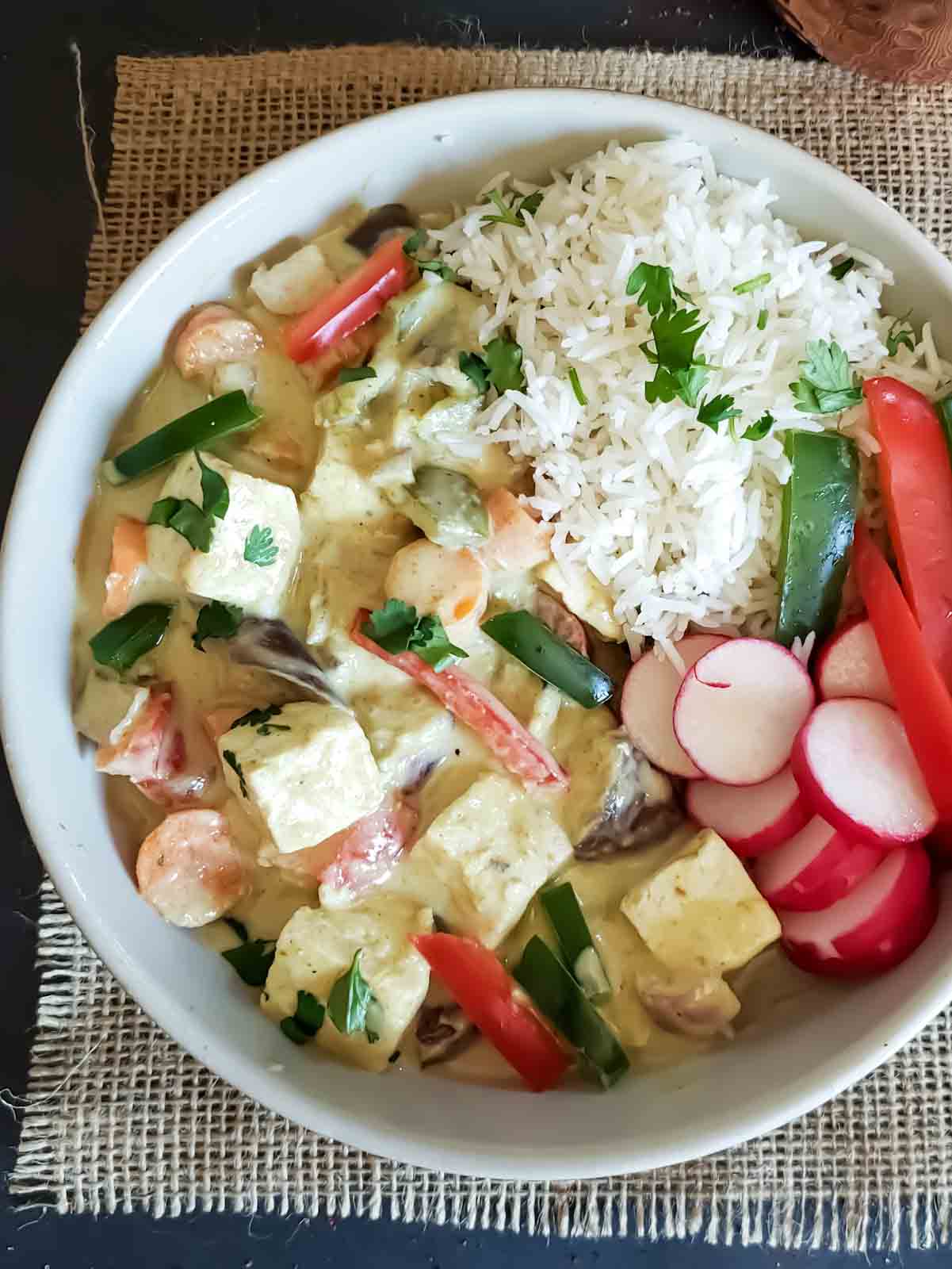 Close up of bowl showing thick, creamy and rich green tofu curry.