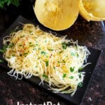 A set up with dinner serving of spaghetti squash with empty shells on the counter and Instantpot in the background.