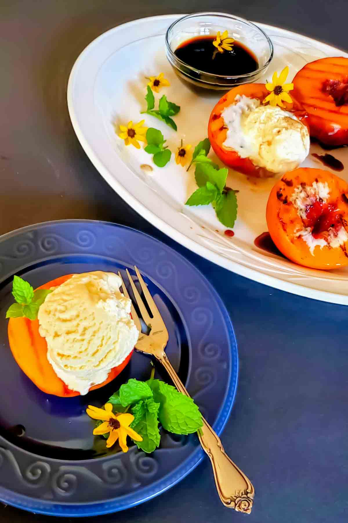 Grilled peaches with maple balsamic glaze served warm.