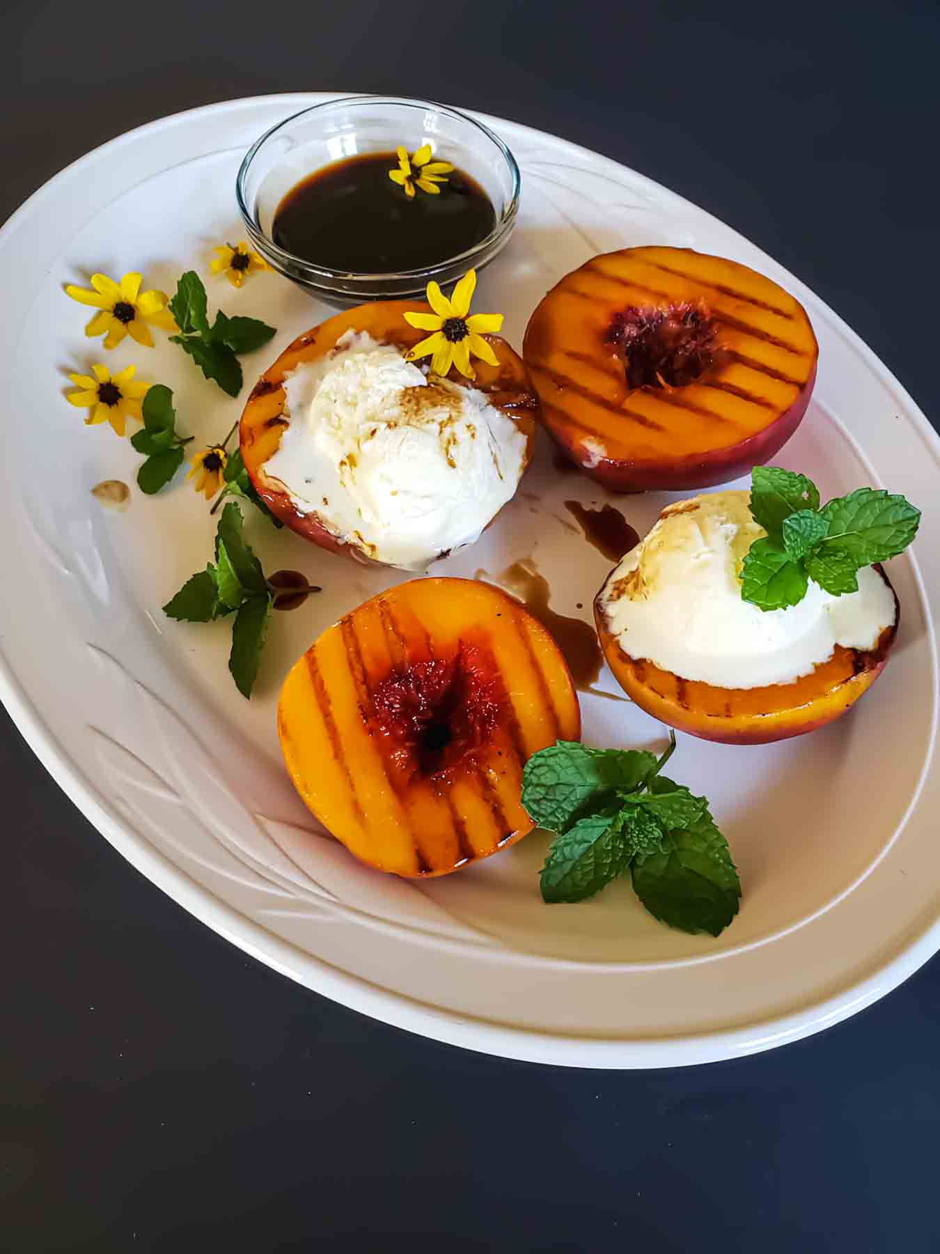 BBQ grilled peaches with vanilla ice cream.