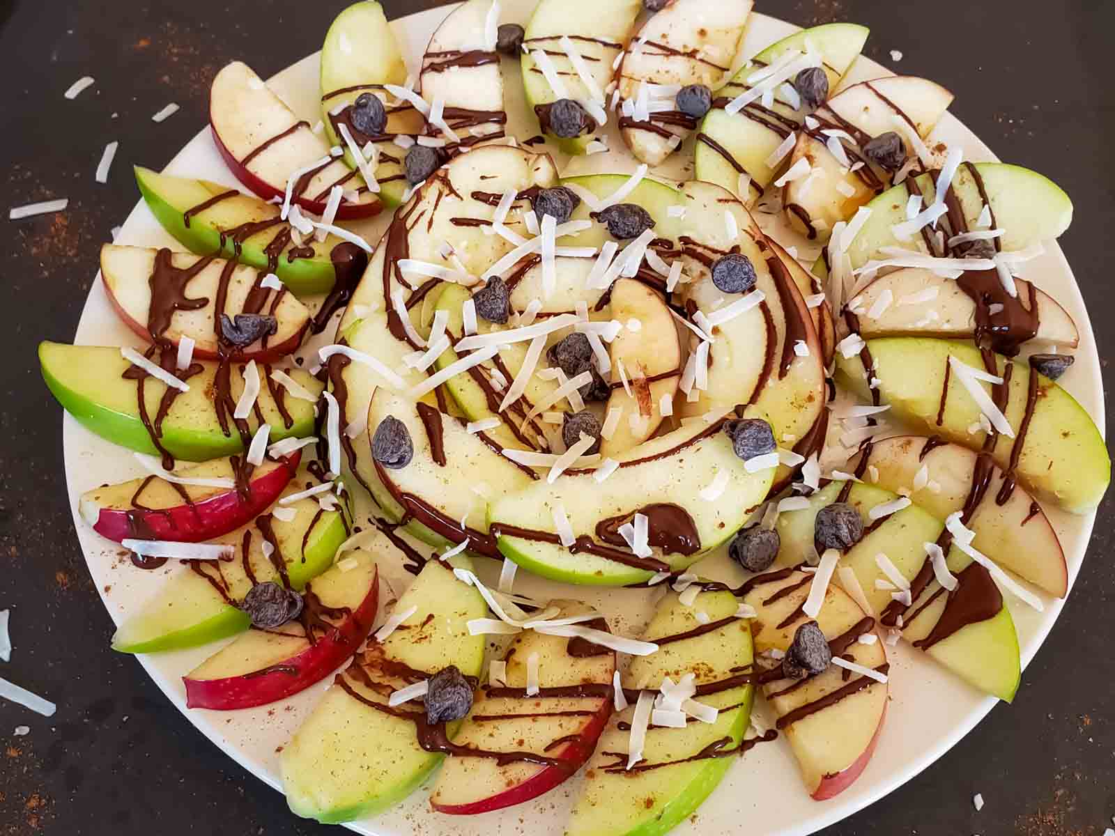 Fruit Nachos with Apples, peanut butter, chocolate drizzle and sweet toppings. 