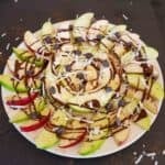 Apple nachos with peanut butter, chocolate, coconut flakes and chocolate chips for a healthy, quick, vegan and gluten-free snack/dessert.