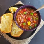 A dinner serving of vegan pepper soup with cheesy garlic toast.