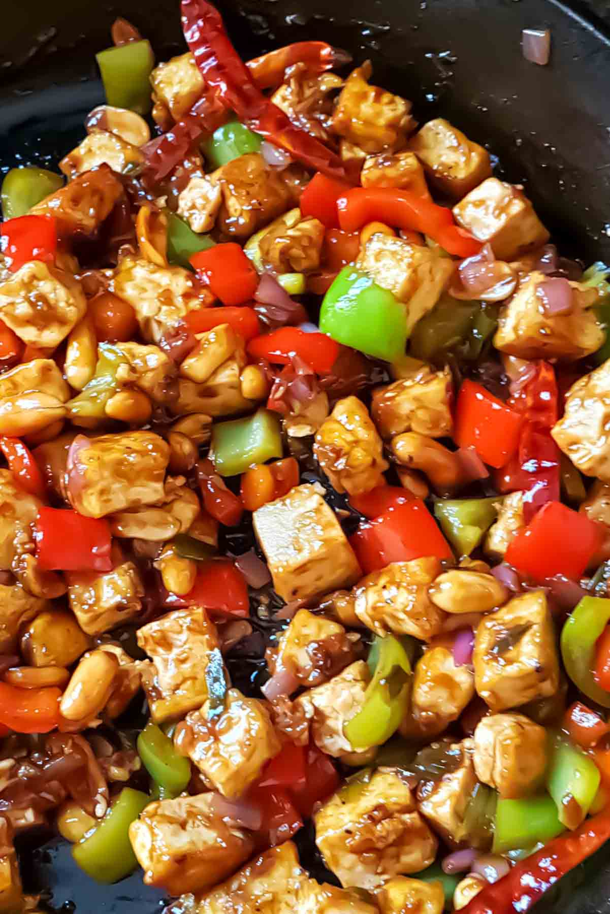 Crispy tofu tossed in spicy Kung Pao sauce with peppers and peanuts.