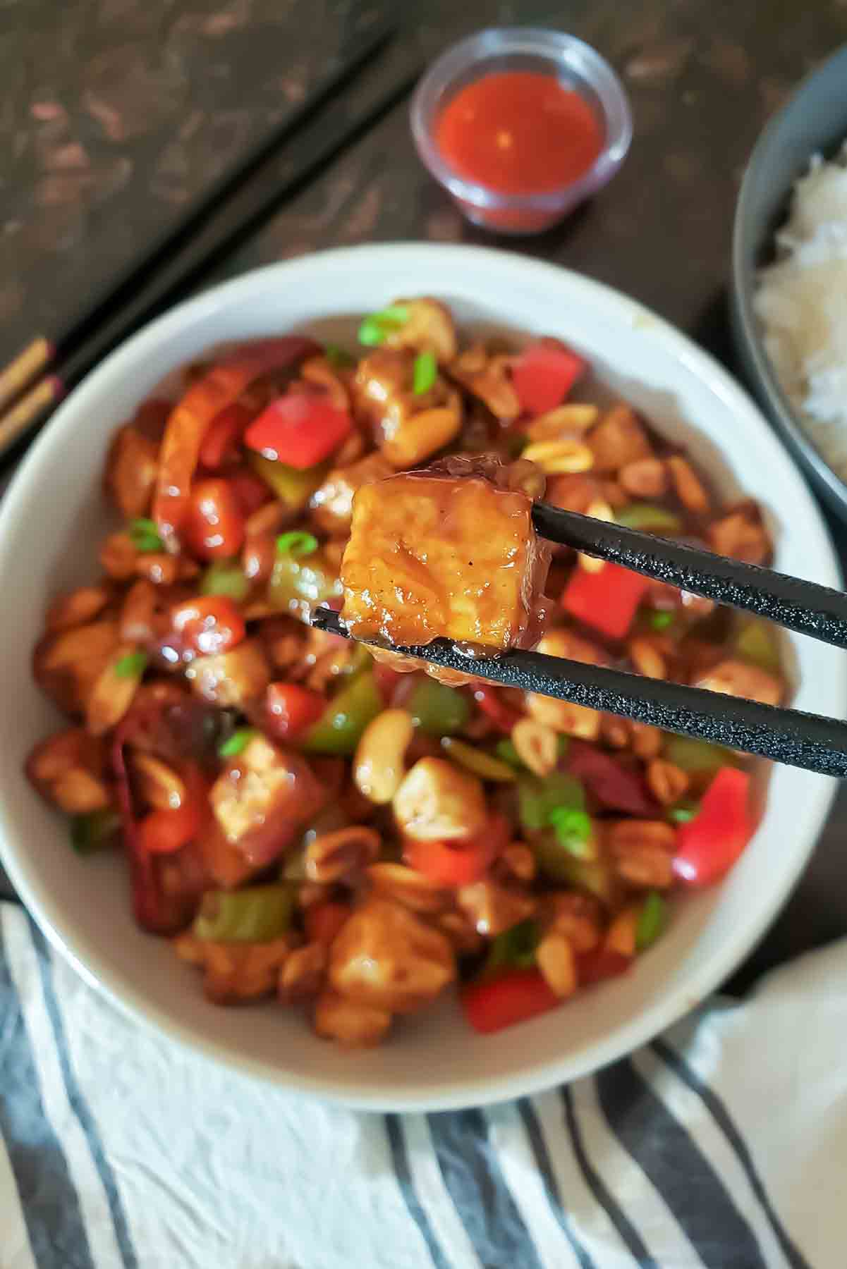 Crispy Kung Pao tofu with bell peppers, peanuts, and dried red chilies.