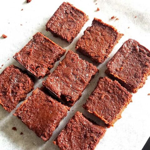 Chocolate Sweet Potato Brownies cut into pieces served on parchement paper.