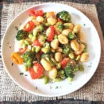 Sheet pan Vegan gnocchi and colorful vegetables baked in the oven and served for dinner.