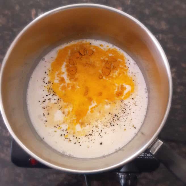 Process shot showing the the milk getting mixed with turmeric and other herbs.
