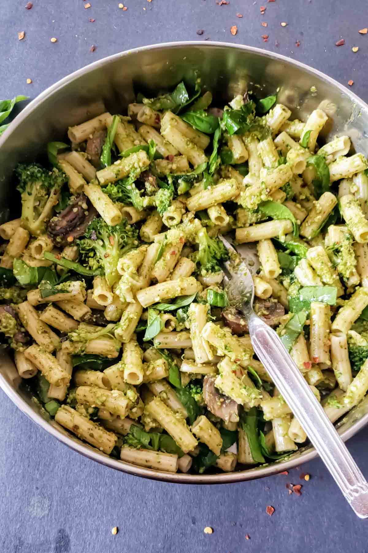Vegetarian pesto pasta primavera with fresh vegetables and penne.