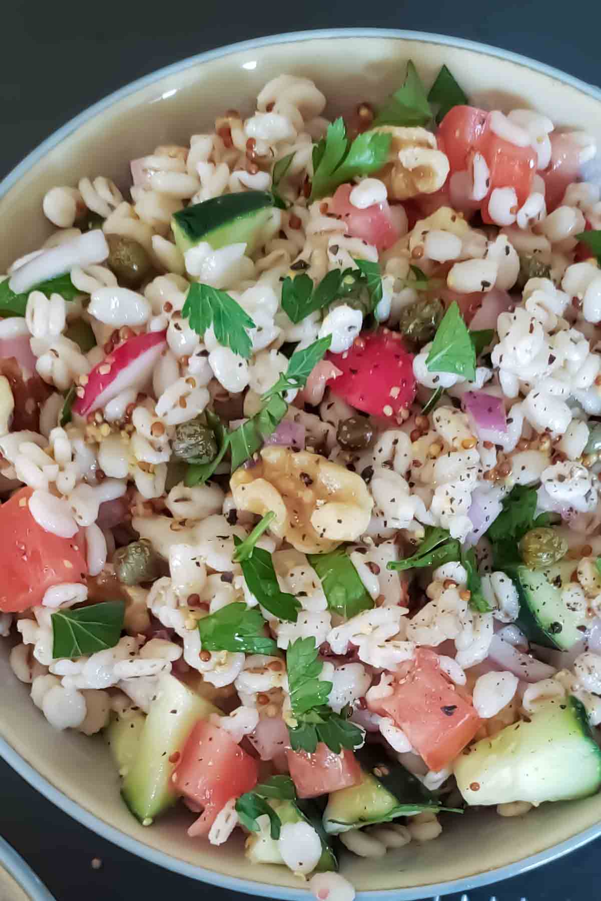 Barley Salad recipe in a bowl with chewy pearl barley, crunchy veggies, and a zesty dressing.