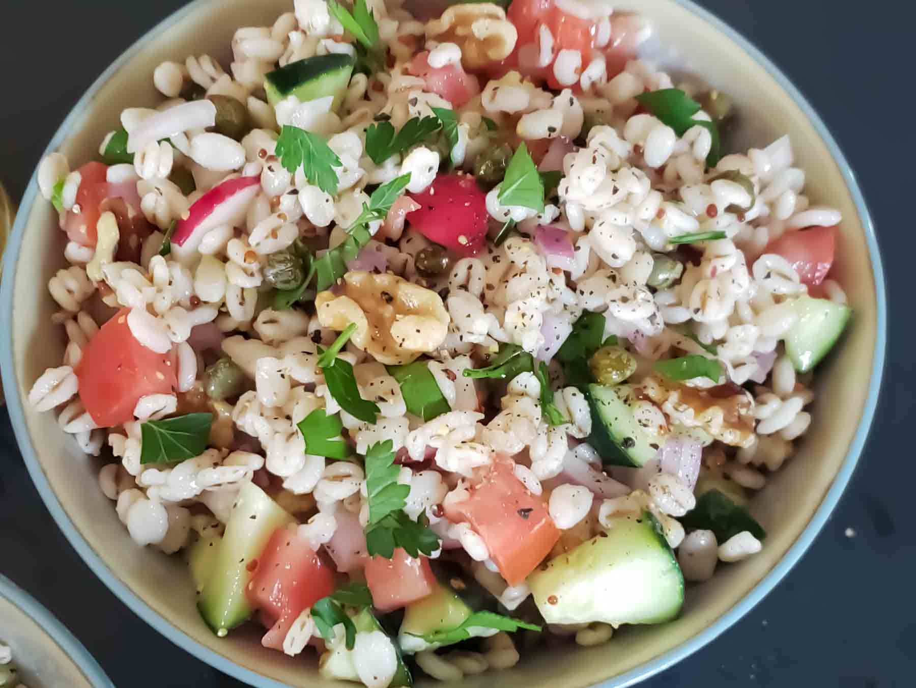 A dinner bowl filled with delicious barley salad.