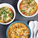 One pot Chickpea Orzo Vegetable soup served in bowls. This vegan recipe with pinterest image has text overlay.