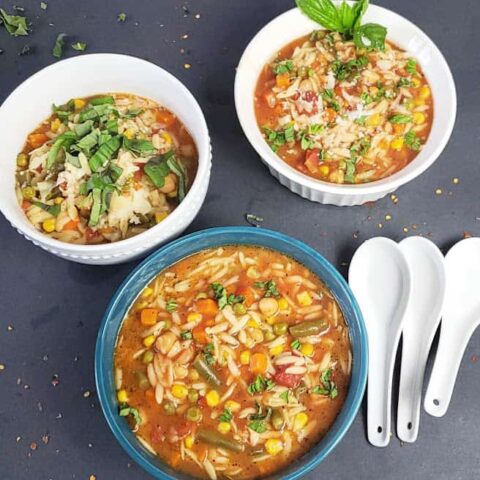 Delicious and easy Vegan Chickpea Orzo Soup garnished and served in soup bowls.