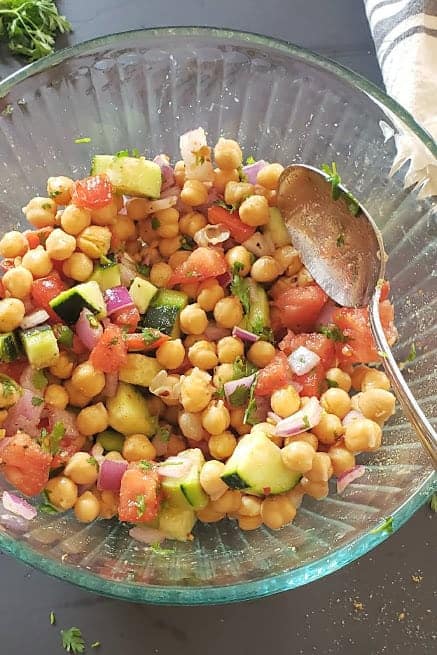 Process shot showing just mixed salad, sitting and resting before serving.