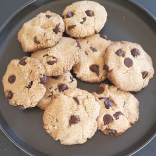 Almond Flour Chocolate CHip cookies served on a plate with dusting of sea salt flakes on the top.