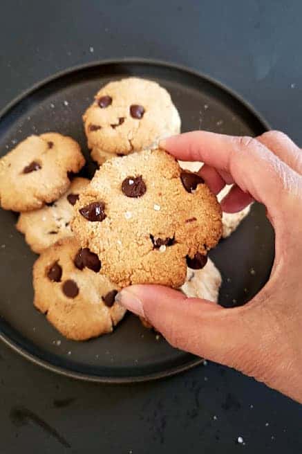 A hand picking up one of the cookies.