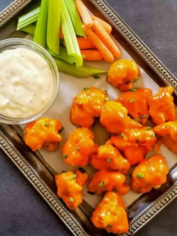 Close-up of buffalo cauliflower wings tossed in spicy sauce copycat recipe.
