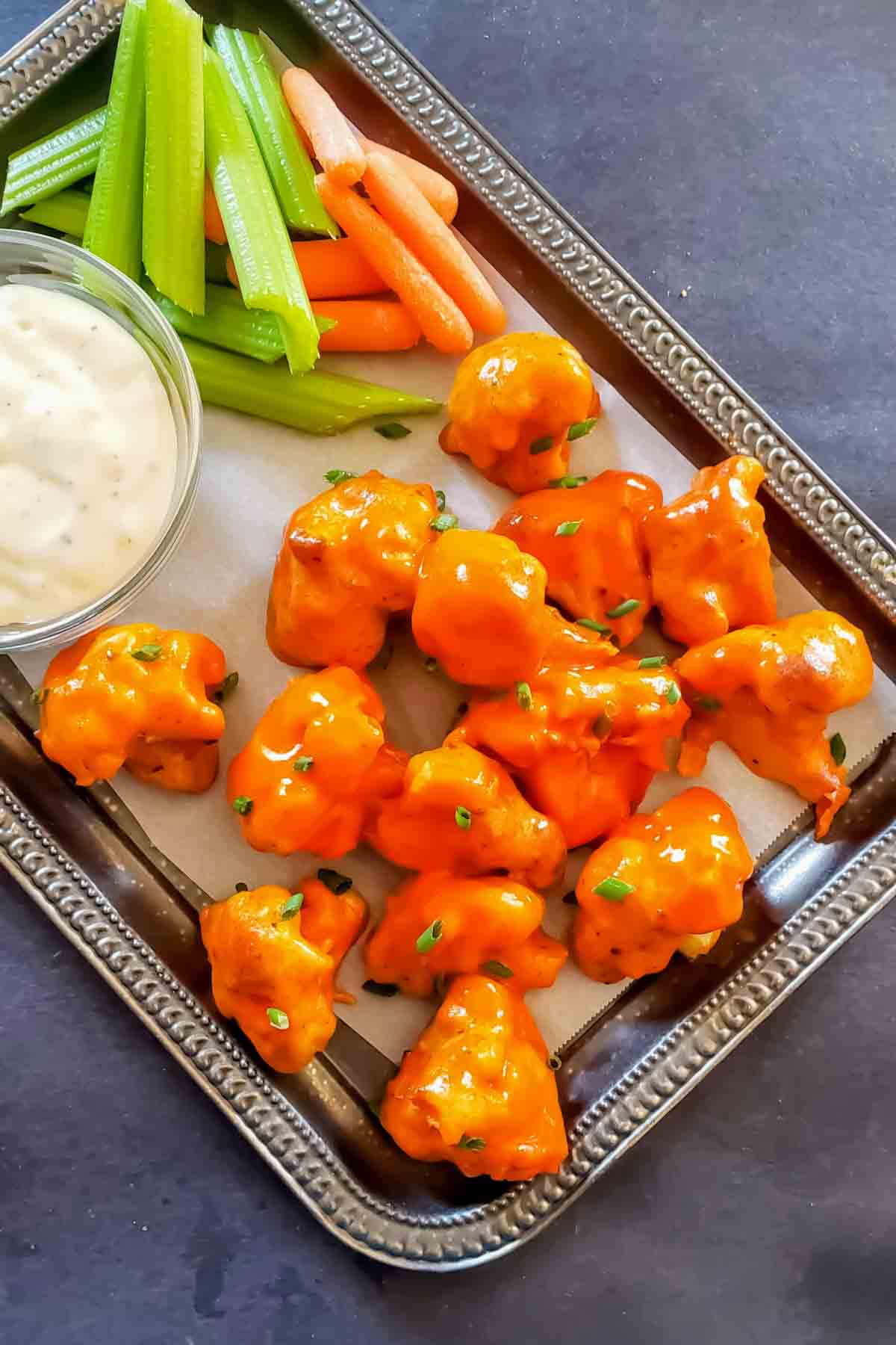 Homemade buffalo wild wings cauliflower wings recipe plated with dipping sauces.