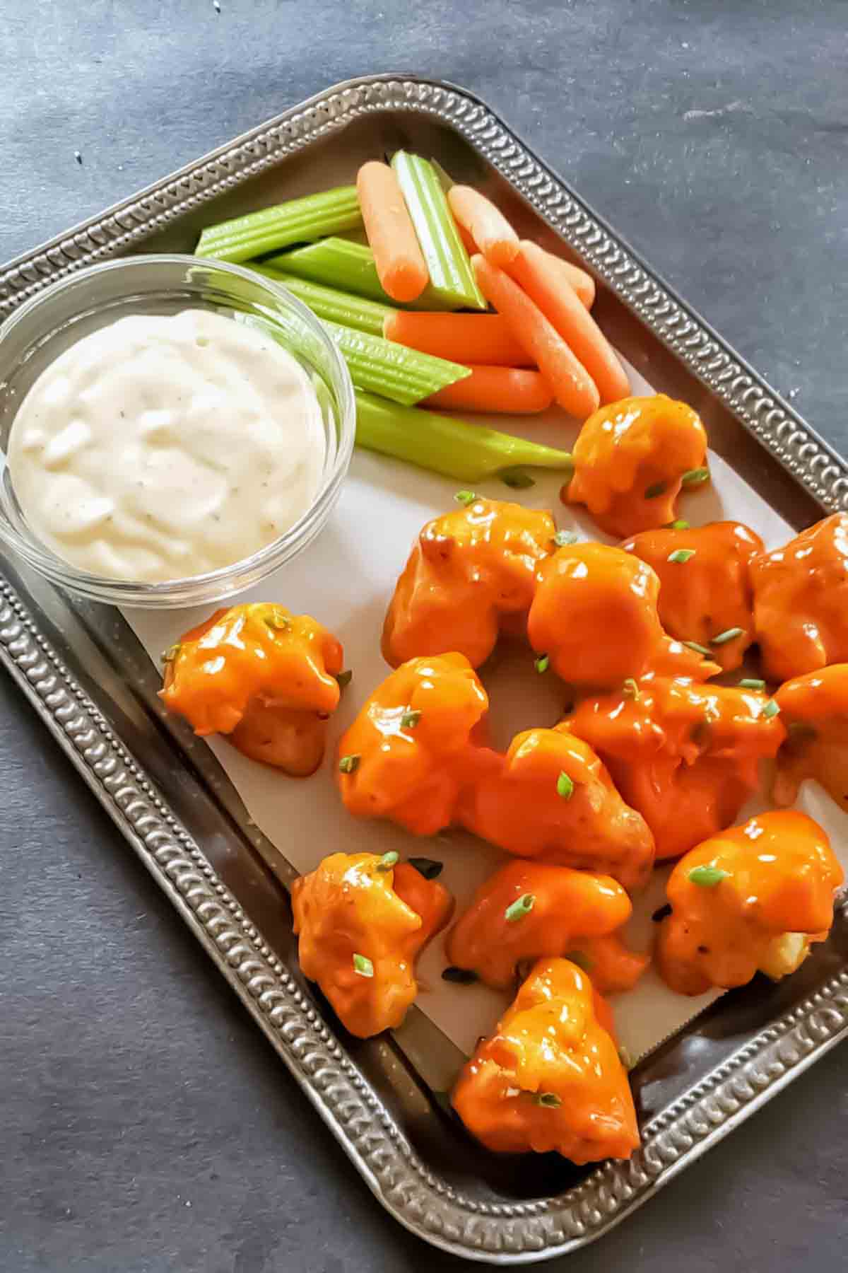 Crispy buffalo wild wings cauliflower wings recipe served with ranch and celery.