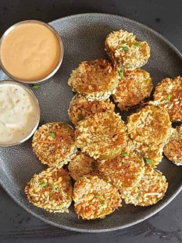 Crispy Air fryer pickles served with two dipping sauces.