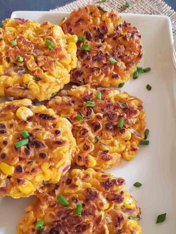Crispy golden air fryer corn fritters made with chickpea flour are served for vegan and gluten-free appetizer.