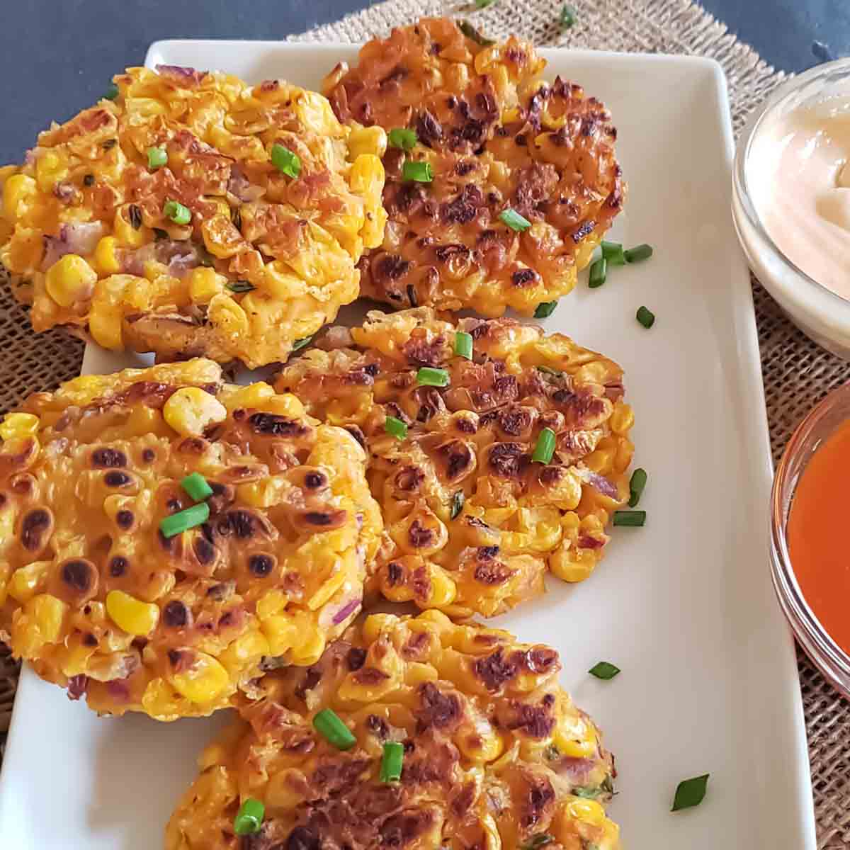 Crispy golden air fryer corn fritters made with chickpea flour are served for vegan and gluten-free appetizer. 