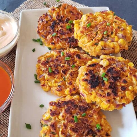 Vegan and gluten free corn fritters made in the air fryer and served with couple of dipping sauces.