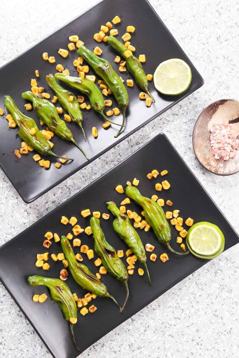 Grilled corn and shishito peppers served as an appetizer.