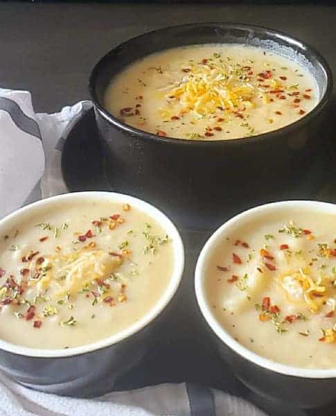 Three bowls filled with creamy dinner soup.