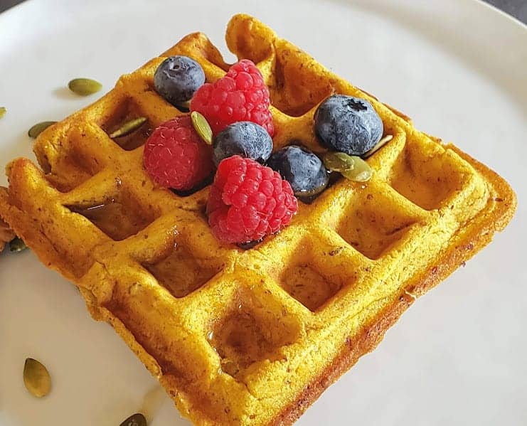 A close up of pumpkin waffle showing light and moist fluffy texture.