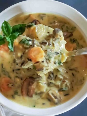 One pot wild rice soup with carrots, celery, mushrooms, and spinach.