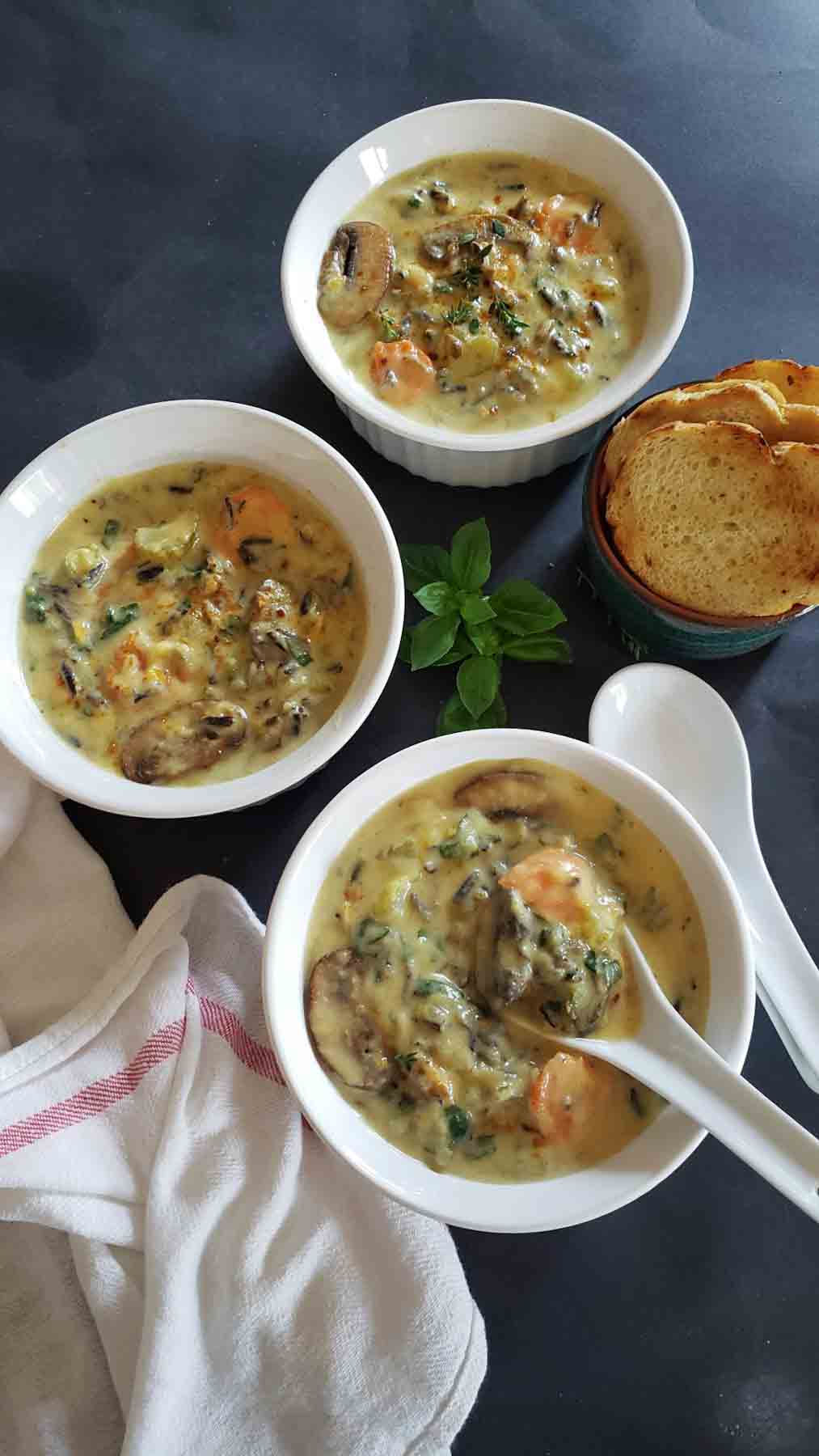 Dinner bowls filled with cozy comforting Mushroom Wild Rice Soup.