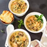 Three soup bowls filled with creamy wild rice mushroom soup made in Instant Pot. This comfort food soup is made with vegan and gluten free ingredients.