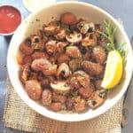 Air Fryer Mushrooms roasted to perfection and served with garnishes.