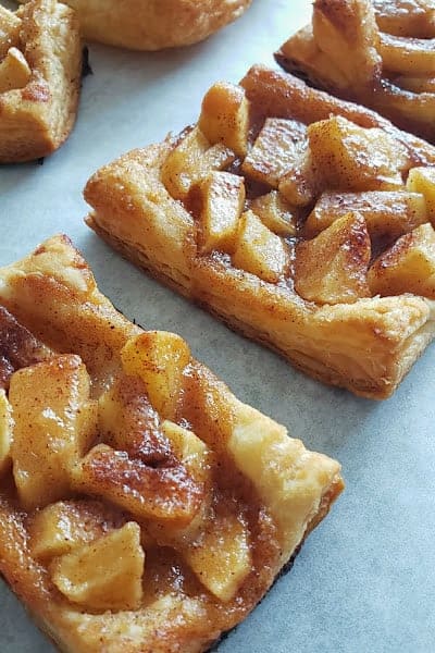 Showing layers of flakey buttery crust and buttery brown apple pie filling.