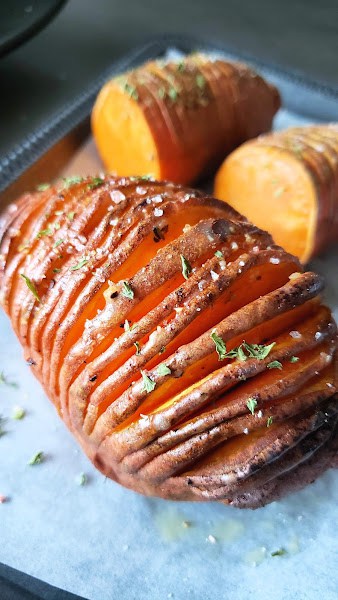 Accordion style cut sweet potatoes roasted and served with maple syrup and smoky tangy spice rub.