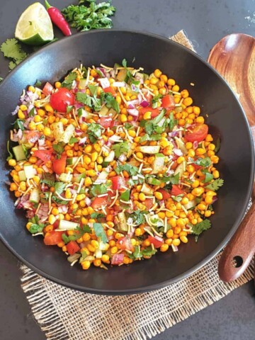 A colorful boondi chat which is spiced fried chickpea puffs served with colorful veggies and scrumptious spices.