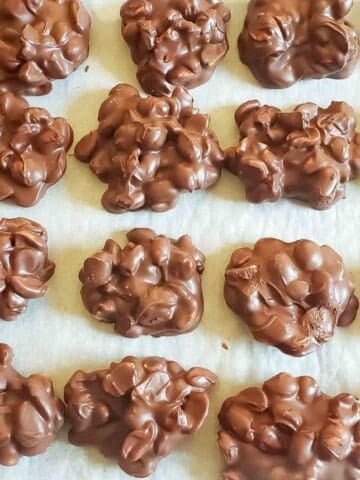 3 ingredient peanut clusters made with chocolate and roasted peanuts for delicious no-bake holiday treat.