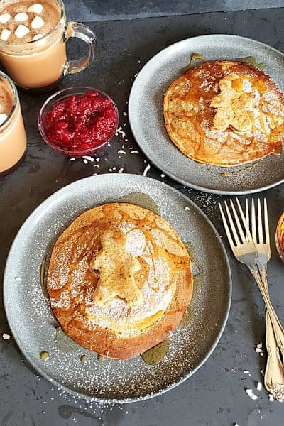 Gingerbread pancakes served with maple syrup and hot cocoa for delicious breakfast.